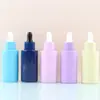 En stock de fábrica Botella gotero con cabeza de goma color macarrón de 40 ml Botella de vidrio de color para aceite esencial Solución madre de esencia dividida en botellas