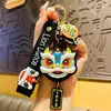 Guanzhou Danza del León Cabeza de León Llavero Colgante Muñeco Tendencia Nacional Adorno de Borla de Año Nuevo Año del Caballo Pequeño Regalo