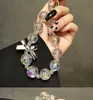 Pulsera con lazo de cuentas transparentes, creativa y distintiva, con cordón corto portátil, llavero universal para funda de teléfono móvil, adorno colgante.