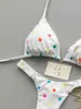 Bikini de lunares blancos de dos piezas para mujer, nuevo estilo verano 2026, cuello halter con lazo, copa triangular, traje de baño sexy reductor