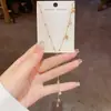 Collar de metal estilo francés de lujo ligero con borla en forma de Y de lirios del valle para mujer, elegante y dulce, diseño versátil, cadena para la clavícula al por mayor