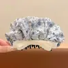 Pinza de plátano en forma de corazón Melard marrón, un accesorio para el cabello sofisticado y minimalista con un lazo y diseño floral