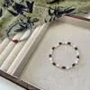 "Camisa de Primavera Delgada" Nuevo Pulsera de Cuentas de Cuerda Código Rojo Ojos de Gato Chino Cuentas de Arroz Verdes Pulsera Elegante Pequeña y Fresca para Mujer