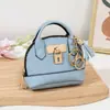Mini bolso de concha de celebridad de internet llavero bolso de mano monedero colgante de bolsa portátil para guardar labial auriculares bolsa pequeña