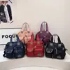 Bolsa tote e bolsa de ombro de grande capacidade e com múltiplos bolsos para mulheres, novo estilo 2026, moderna e casual, feita de tecido Oxford espessado, adequada para viagens