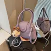 Moda Versátil Transfronteriza Verano 2026 Nuevo Diseño de Nicho Exquisito para Viajar de un Lado a Otro Bolso de Hombro Cruzado de Concha de Gama Alta