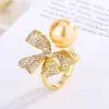 Anillo de Moda Huabi Jewelry 2024 Chapado en Cobre Dorado con Perla y Moño para Mujer 12mm