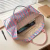 Bolso de mano de PVC a rayas transfronterizo nuevo, bolso de mano elegante y ligero, bolso de hombro portátil de gran capacidad para viajes