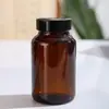 Botellas cápsula de vidrio ámbar de 60 ml al por mayor, botellas selladas a prueba de luz para reactivos, vitaminas para el cuidado de la salud y productos de bienestar, botellas vacías para dispensar
