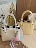 Bolso de cubo de mano minimalista de nicho Shuai Mi Jia 2026 verano nuevo estilo coreano moderno y a la moda bolso de hombro cruzado