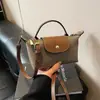 Moda Retro Versátil Transfronterizo Explosiones 2025 Nuevo Bolso de Mujer Hombro Cruzado Portátil a Mano Nylon de Gama Alta Bolso Dumpling