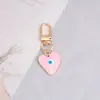 Nueva Joyería Simple Transfronteriza Creativo Colgante de Arena Movediza Ojo del Diablo Colgante de Llavero Metálico con Forma de Corazón Gota de Aceite