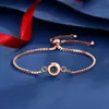 Pulsera de proyección con texto nanomicrotallado "Te amo" en 100 idiomas, estilo europeo y americano, con bocetos a color.