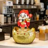 Dios de la Riqueza sonriente sentado sobre un lingote de oro, una alcancía decorativa para tiendas, un amuleto de la suerte para la caja registradora, un regalo para la inauguración de una tienda o una casa nueva