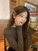 Nuevo suéter de otoño e invierno con ribete de volantes, cuello semi-alto, mangas largas, base de punto, estilo coreano, elegante y ajustado, top interior para mujer