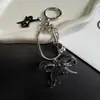 Nuevo y exquisitamente elegante correa para teléfono de nudo de lazo y hueso de serpiente, llavero corto versátil y accesorio para bolso