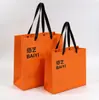 Bolsa de tote de papel recubierto impresión de LOGOTIPO personalizado fabricante venta al por mayor naranja bolsa de regalo bolsa de compras impresión personalizada