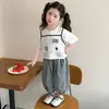 Conjunto de Ropa para Niñas 2026 Nuevo Conjunto de Moda Estilo Coreano para Niñas Pequeñas, Conjunto de Dos Piezas con Estampado de Gato y Pantalones de Cuadros Blanco y Negro para Niños Pequeños y Niños Pequeños