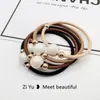 Nueva cuerda para el pelo simple de perlas, diadema, banda elástica, cuerda para la cabeza con cubierta de cuero para mujer, versión coreana de Banda Elástica al por mayor, anillo para el pelo de alta elasticidad