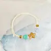 Jingdezhen Navidad Pulsera de Cuerda Trenzada de Cerámica Pulsera de Trébol de Cuatro Hojas Joyería Artística Hecha a Mano Venta al por Mayor Pulseras de Cerámica para Atracciones Turísticas
