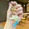 Colgante llavero temática oceánica, diseño de caballito de mar y estrella de mar en acrílico, llavero creativo de arena líquida brillante, pequeño regalo