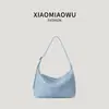 Bolso tejido de piel sintética PU suave coreana, bolso de mano de moda para vacaciones en la playa, diseño versátil de nicho, adecuado para el trabajo, bolso de hombro bajo el brazo