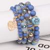 Pulsera de borlas con colgante de amor hueco multicapa de estilo bohemio de venta caliente europeo y americano, juego de joyería multicapa con cuentas de vidrio