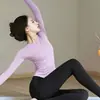 Conjunto de yoga y fitness de alta gama para mujer, con un top deportivo de manga larga y pantalones de pierna de tiburón de cintura alta, diseñado para entrenamiento profesional de Pilates