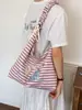 Bolsa de mano rayada transfronteriza para mujer, nueva moda de verano 2026, bolsa escolar grande para estudiantes, bolso de hombro y cruzado
