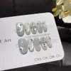 Céu Claro CrossCool e Leve Estilo Gótico Desejo Puro Unhas Vestíveis Feitas à Mão em Branco Leitoso e Azul Gelo com Arte de Unhas 3D de Cruz e Estrela