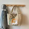 Versión Coreana de la Bolsa de Lona Ins Gato Lindo de Gran Capacidad para Mujer 2026 Nuevo Modelo Estudiante Clase Viaje Diario Bolso de Hombro