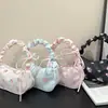 Bolso de hombro con cordón de comercio exterior para mujer con lazo, bolso cruzado pequeño floral versátil, bolso de mano para debajo del brazo, bolso plisado casual para mujer