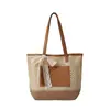 Bolso de paja casual de moda para mujer, nuevo modelo primavera 2026, bolso tejido de gran capacidad para el trabajo y los desplazamientos, bolso de axila de alta gama