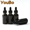 Botella gotero de vidrio Boston transparente negro para cosméticos líquidos, aceite esencial, 30 ml, caja de envío transfronterizo