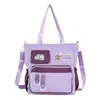 Bolsa de ombro para estudante do ensino fundamental, unissex, casual, grande capacidade, adequada para a escola e aulas de reforço, bolsa transversal, bolsa tote de lona versátil