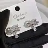 Brincos de Laço com Pedras Full Diamond e Gota d'Água com Design de Luxo Leve, Estilo Nicho de Alta Qualidade, Acessório de Moda Elegante e Versátil para Mulheres