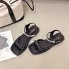 Sandalias de Exterior con Tacón Grueso de Estilo Cómodo Sandalias Planas de Una Sola Tira para Mujer Verano 2026 Retro Francés Lazo de Perla