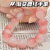 Pulsera de mujer con texto en inglés "Bodhi hand string around the finger", versión para estudiantes, con degradado suave en azul melocotón y rosa.