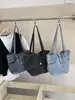 Bolso de axila de diseño retro de nicho transfronterizo para mujer, bolso de mano de lona simple y elegante, bolso de hombro casual y único para el día a día