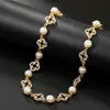 Collar europeo y americano de joyería transfronteriza, collar empalmado de flor hueca de perla artificial, cadena para la clavícula de trébol de cuatro hojas con incrustaciones de diamantes de nicho de lujo ligero para mujer