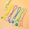 Venta al por mayor de pequeños, frescos, estilo coreano, flor de girasol acrílica, flor de goma suave, cordón trenzado hecho a mano, accesorios para cordón de teléfono