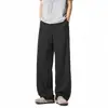 Textura refrescante pantalones rectos color albaricoque claro líneas segmentadas tridimensionales holgados adelgazantes ligeros con caída pantalones hasta el suelo moda masculina