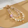 Nuevo colgante de teléfono de doble cadena con un toque de alta gama, cuentas luminosas de flor de cerezo, correa de muñeca para teléfono, charm para bolso, pequeño regalo para mujeres