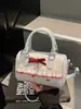 2026 Nova Bolsa de Mão Doce com Laço de Alto Valor Pequena Versátil para o Dia a Dia Bolsa Transversal para Mulheres