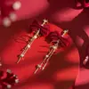 Brincos Rotativos de Meteoro de Natal Outono e Inverno Ano Novo Brincos com Laço Vermelho Doce Design de Nicho Sentido Design Feminino Atacado