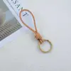 Pulseira feita à mão corda de couro chaveiro casal simples pingente trançado corda de couro vintage corda de chaveiro pingente de bolsa joia