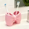Portacepillos de dientes con forma de lazo superventas transfronterizo, estante para cepillo de dientes y pasta de dientes de lavabo, soporte de almacenamiento, organizador de cepillos de dientes de escritorio