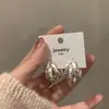 Pendientes de anillo liso exagerado con aguja de plata S925 de estilo europeo y americano para mujer, pendientes de temperamento simple Joker de lujo ligero de alta gama, venta al por mayor