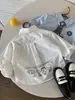 Camisas para Niños 2026 Otoño Nuevo Estampado Digital Dibujos Animados Camisas Personalizadas Bebé Estilo Coreano Versátil Camisas de Algodón de Color Sólido