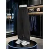 Novas calças casuais masculinas de outono e inverno com cordão, cor sólida, tamanhos grandes, calças curvas de corte inclinado estilo americano, calças esportivas masculinas de perna reta